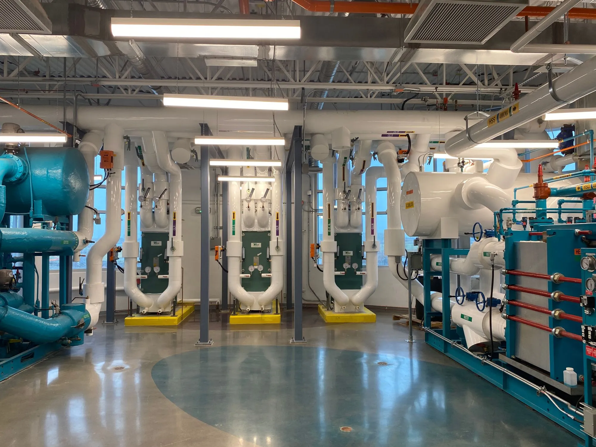 Commercial mechanical room with HVAC piping and climate-control equipment